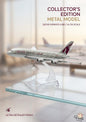 Metal model of a Qatar Airways airplane on a glass display stand with blurred background