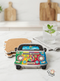 Set of three retro Lebanon peace van ceramic coasters with cork backing next to a glass of water