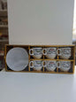 Set of six white cups with Arabic text in a decorative box on a white surface.