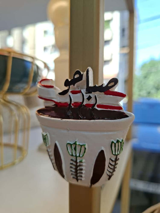 Small cup with a decorative design on a blurred background