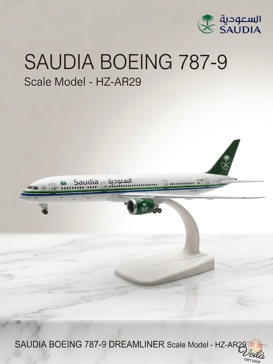 Model of Saudia Boeing 787-9 airplane on a white marble surface with Saudia branding.