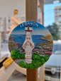 Decorative magnet with a scenic view of Lebanon featuring a statue and flag.