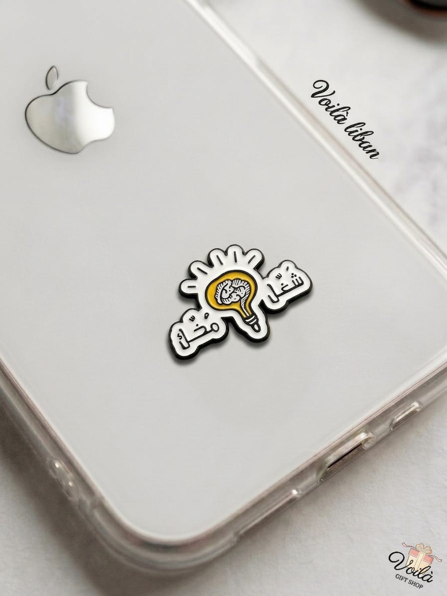 Phone case with a sticker of a brain and light bulb on a white surface