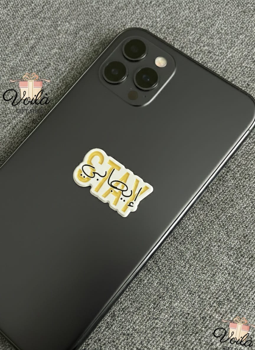 Black phone case with 'Stay High' sticker on a gray textured background