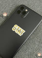 Black phone case with 'Stay High' sticker on a gray textured background