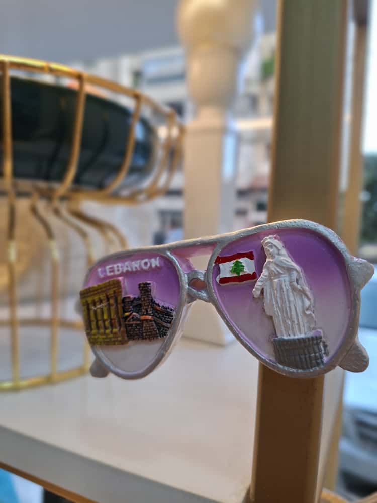 Sunglasses with Lebanese designs on a display stand