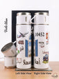 Two white thermos bottles with travel-themed designs on a wooden surface.