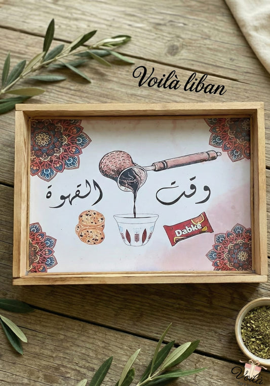 Decorative tray with coffee-themed design and 'Voila liban' branding on a wooden surface.