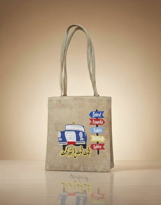 Beige tote bag with colorful graphics on a beige background