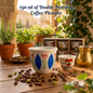 Traditional Lebanese ceramic coffee cup with classic blue and red tulip design on a wooden table with coffee beans