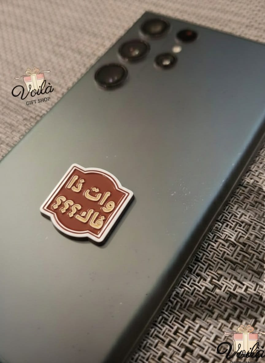 Smartphone with a decorative sticker on a textured surface