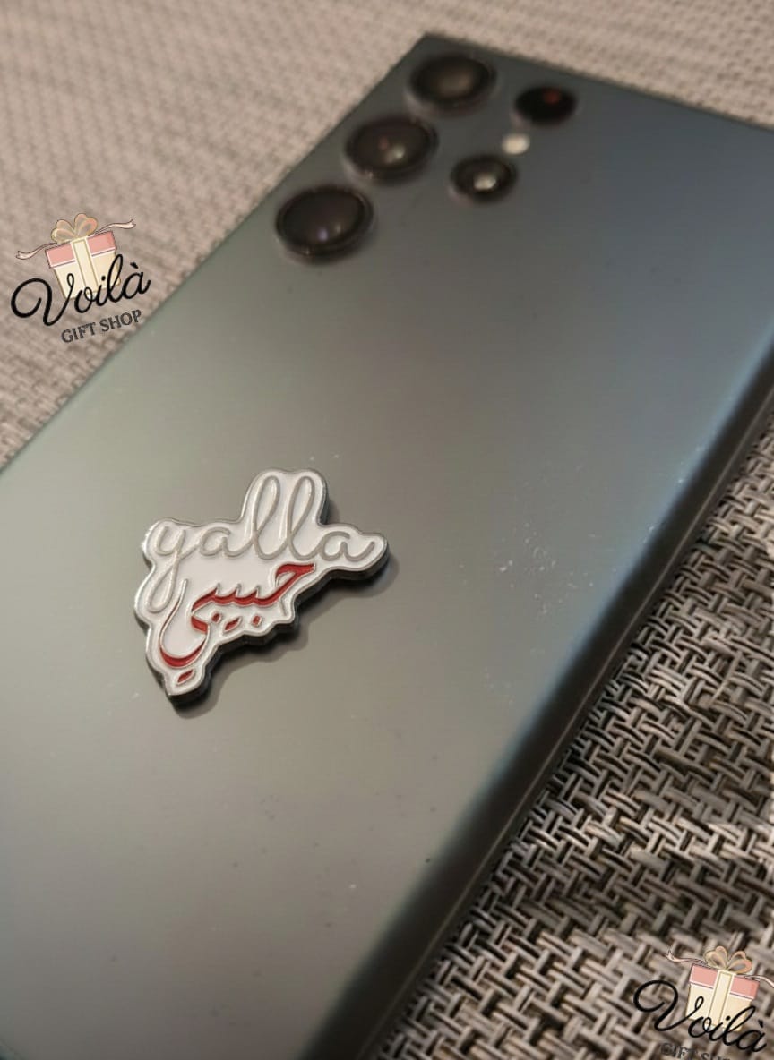 Phone case with 'yalla' text on a textured surface