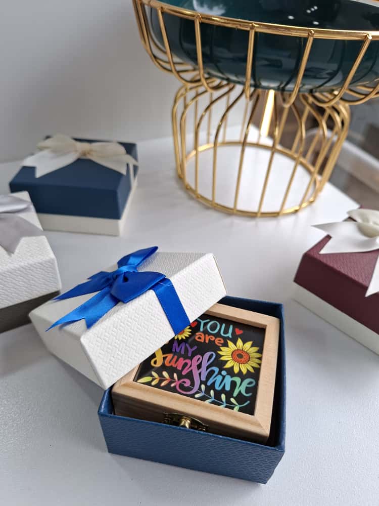 Gift box with a colorful card inside on a white surface