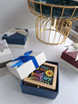 Gift box with a colorful card inside on a white surface