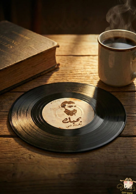Vinyl record with a portrait and text on a wooden table with a steaming cup of coffee.